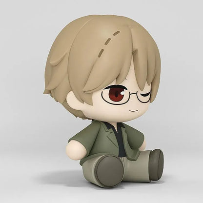 Shuichi Natori Huggy Good Smile figure seated in a green jacket and glasses with a playful winking expression.