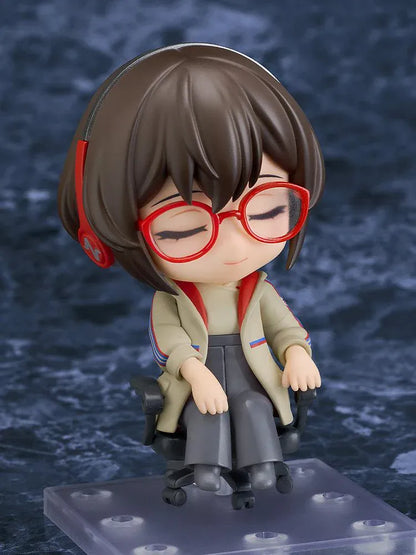 Nendoroid Satone figure seated in a black office chair, wearing red glasses, red headphones, a beige jacket, and dark gray trousers.