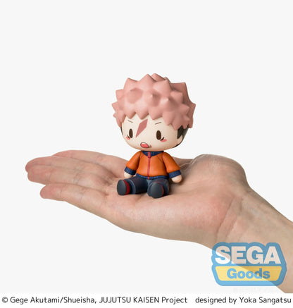 Yuji Itadori chibi figure in a seated pose with pink hair, facial markings, and an orange and navy outfit.