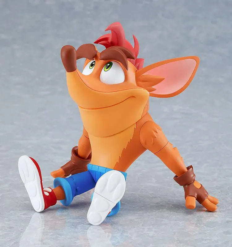 Crash Bandicoot Nendoroid rerelease figure with orange fur, a large grin, blue shorts, and red sneakers in an energetic pose.