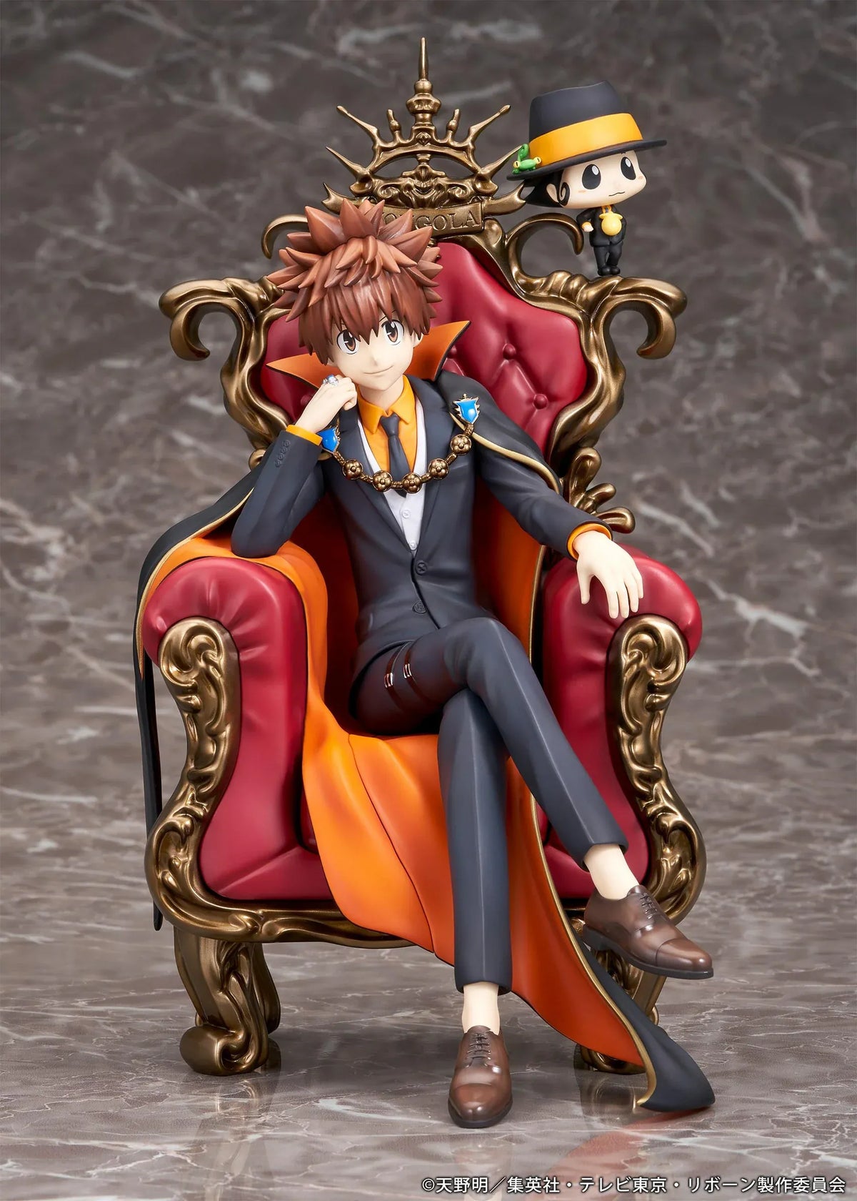 REBORN! Tsunayoshi Sawada & Reborn Scale Figure featuring Tsuna with spiky brown hair, a fiery Dying Will Flame, black suit, and orange-lined cape seated on an ornate golden throne with red upholstery, accompanied by Reborn in his signature fedora.