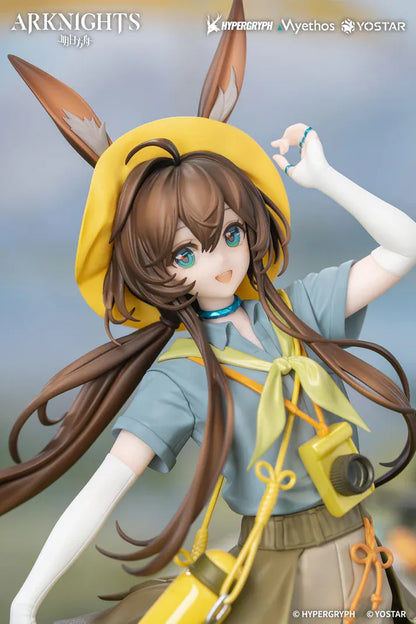 Arknights Gift+ Amiya Wildlight Wander Ver. 1/8 Scale Figure featuring Amiya with rabbit ears, hooded outfit, camera accessory, yellow bag, and themed display base.
