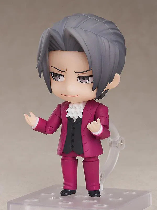 Ace Attorney Miles Edgeworth Nendoroid rerelease figure wearing a burgundy suit and pointing beside a Japanese Objection effect part.