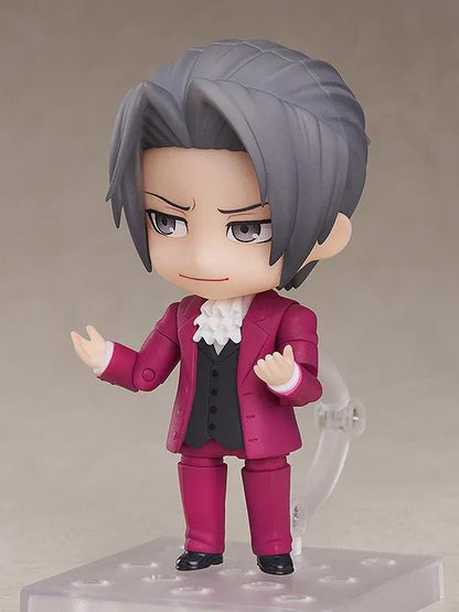 Ace Attorney Miles Edgeworth Nendoroid rerelease figure wearing a burgundy suit and pointing beside a Japanese Objection effect part.