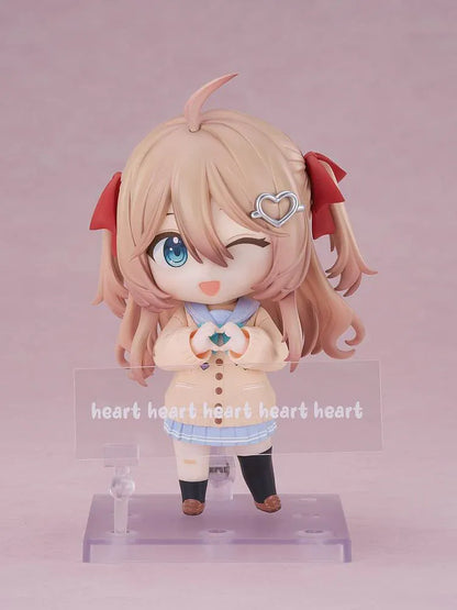 Neuro-sama Nendoroid figure with light brown hair, red ribbons, a heart hair clip, peach cardigan, turquoise bow, and a green turtle on her head.
