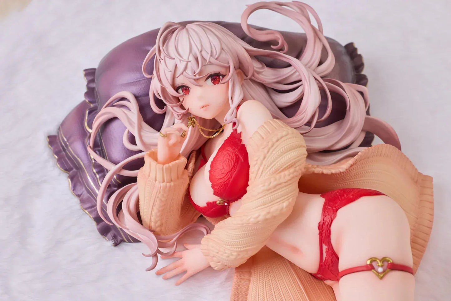Makia 1/7 scale figure lying on a large fluffy white round base, wearing a cardigan and red lingerie, resting on a purple pillow