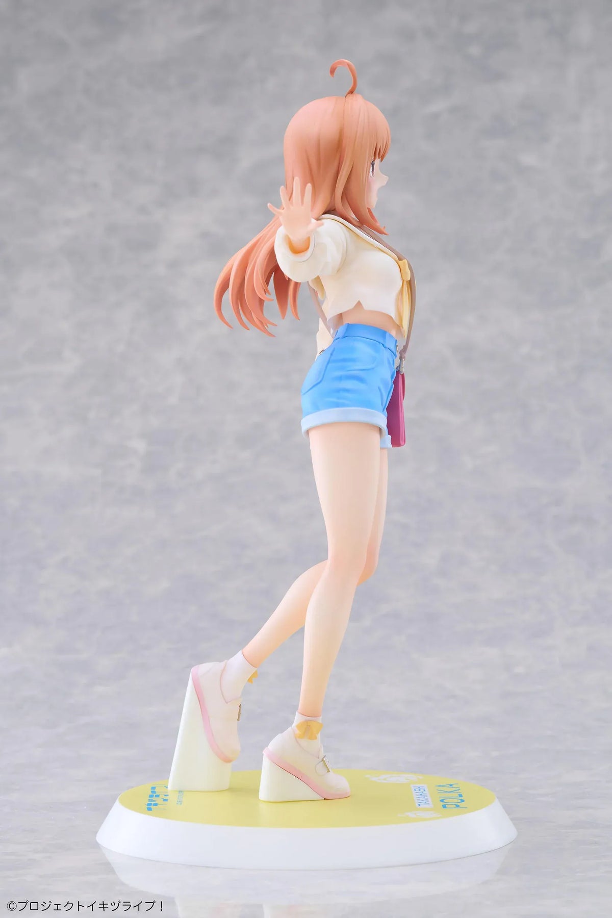 Polka Takahashi 1/7 scale figure with orange hair, a white sailor-style top, blue shorts, and a pink shoulder bag, posed on a yellow base.