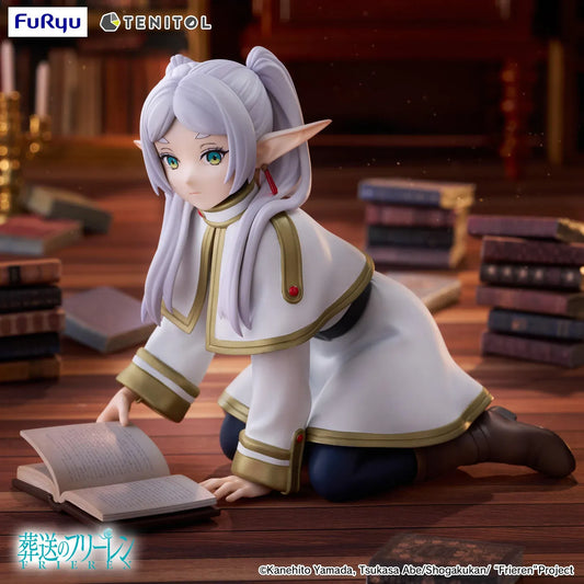 TENITOL Frieren [petit] figure kneeling over an open book, wearing a white and gold outfit with silver twin tails, pointed ears, and brown boots.