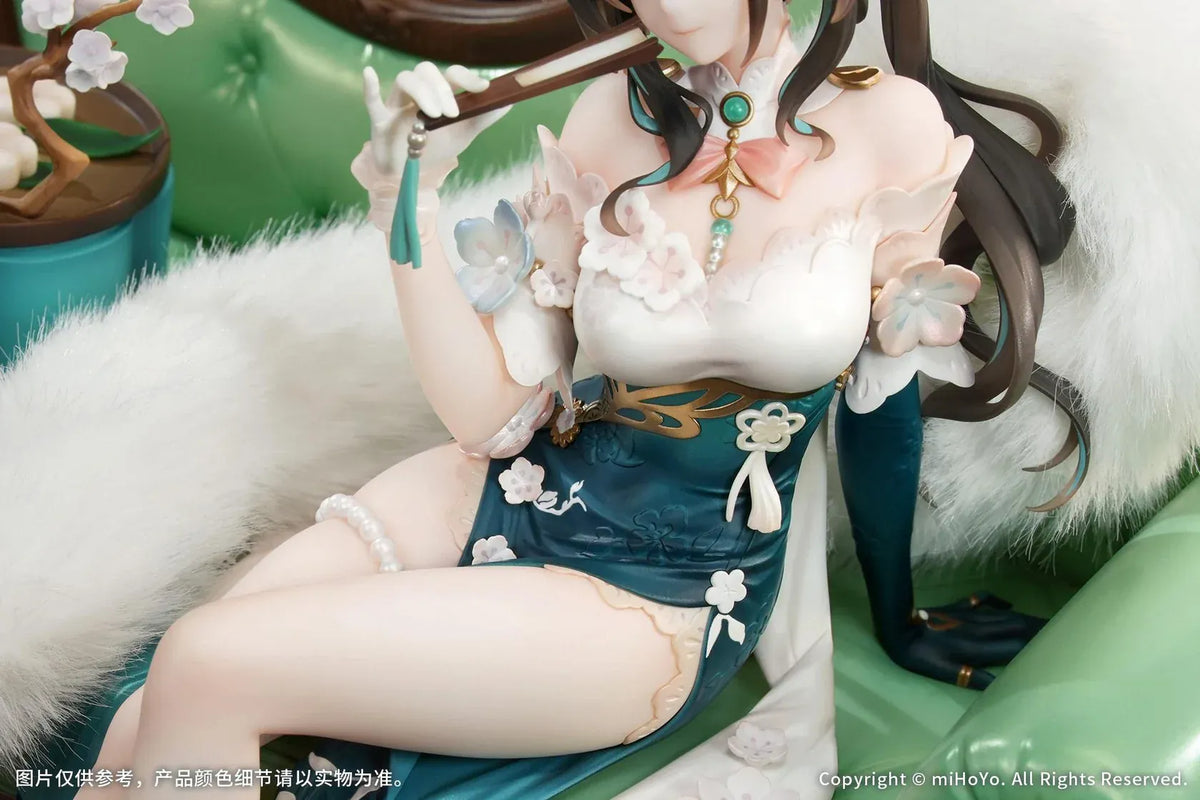 Ruan Mei Plumblossom Letter 1/7 scale figure wearing an elegant teal-and-white floral dress while seated on an ornate green sofa.