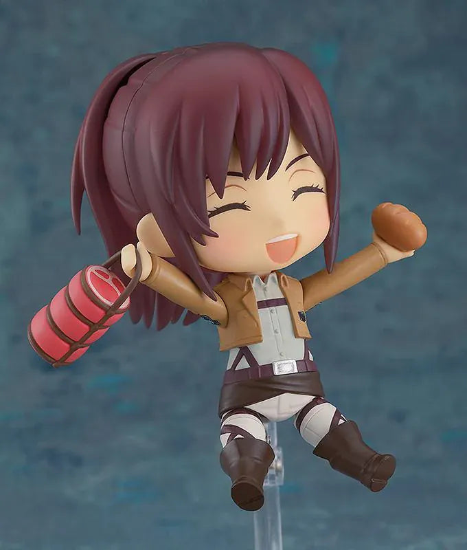 Attack on Titan Nendoroid Sasha Braus rerelease figure wearing her Survey Corps uniform and green cloak with dual blades and maneuvering gear.