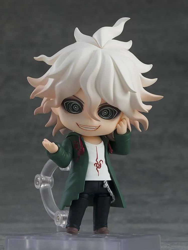 Nendoroid Nagito Komaeda with tousled white hair, pale green eyes, a green coat, white printed shirt, and black trousers, extending one hand.