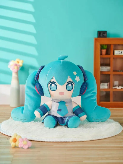 Hatsune Miku Huggy Doll plushie with turquoise twin tails, flower-shaped embroidered eyes, and her signature outfit.