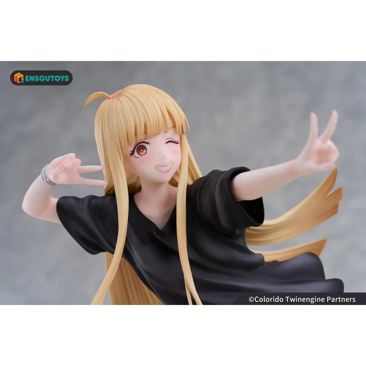 Kaguya In the Real World Ver. 1/7 scale figure with flowing blonde hair, a black outfit, blue sneakers, and a winking peace-sign pose.