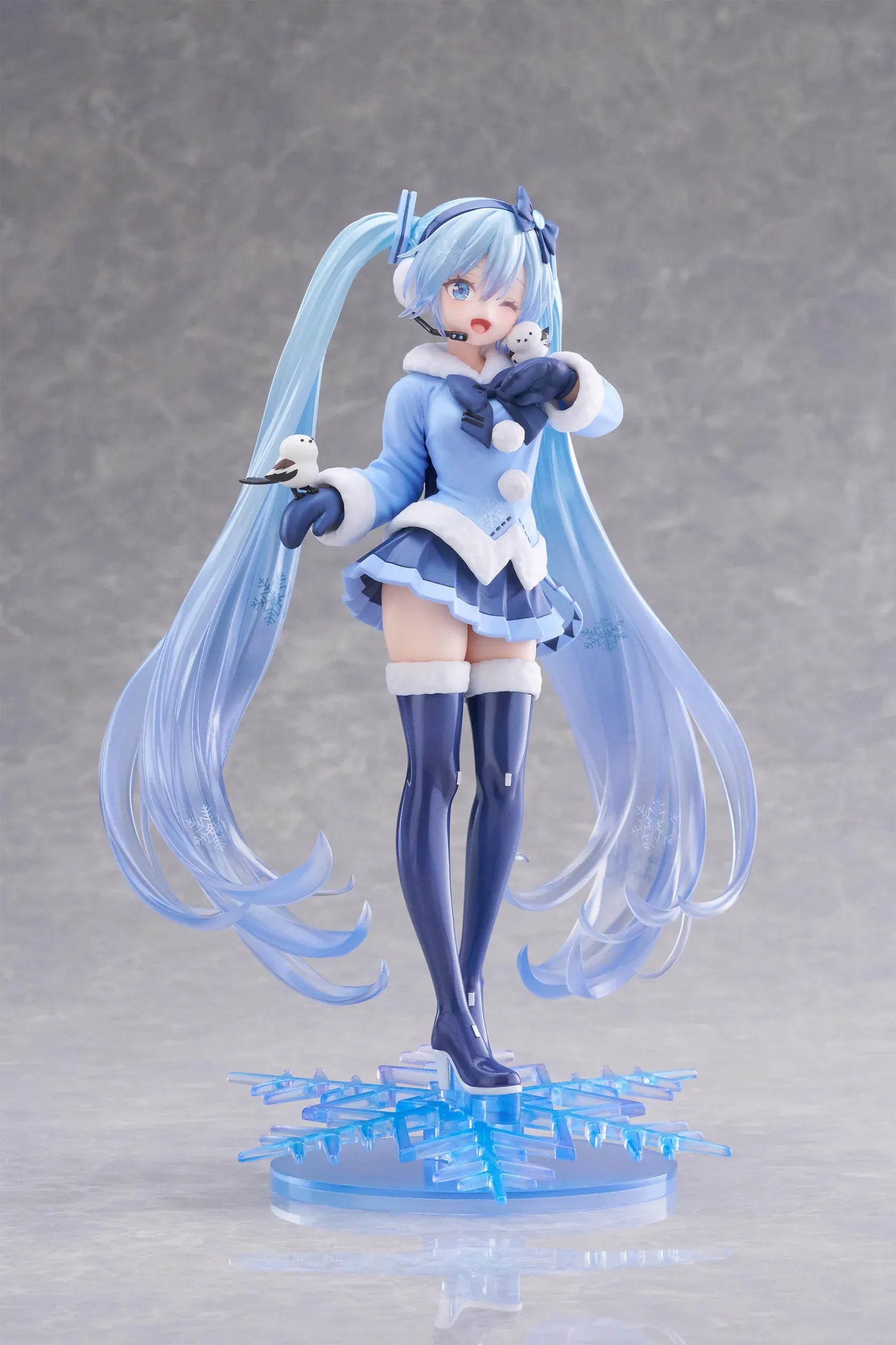Vocaloid AMP+ Snow Miku All Stars 2012 Ver. Figure with icy blue twin-tails, winter outfit, bird details, and snowflake display base