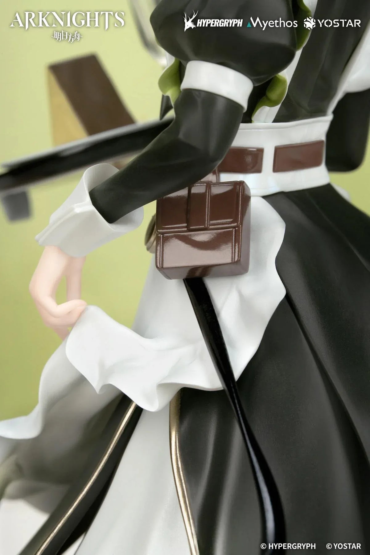 Kal'tsit The Remains of Time Ver. figure wearing a flowing black and white maid dress and holding a serving tray on a translucent green base.