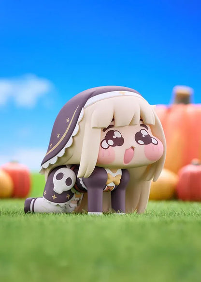 POP UP PARADE Petite Speaki figure with blonde hair, sparkling eyes, rosy cheeks, and a dark hood with gold accents and a skull detail.