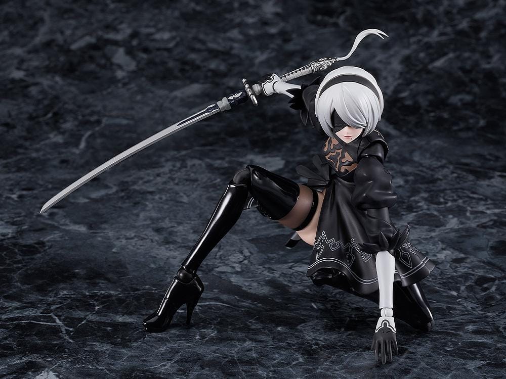 NieR Ver1.1a figma 2B figure with silver hair, a black visor, patterned black outfit, white sleeves, glossy boots, and a support robot.