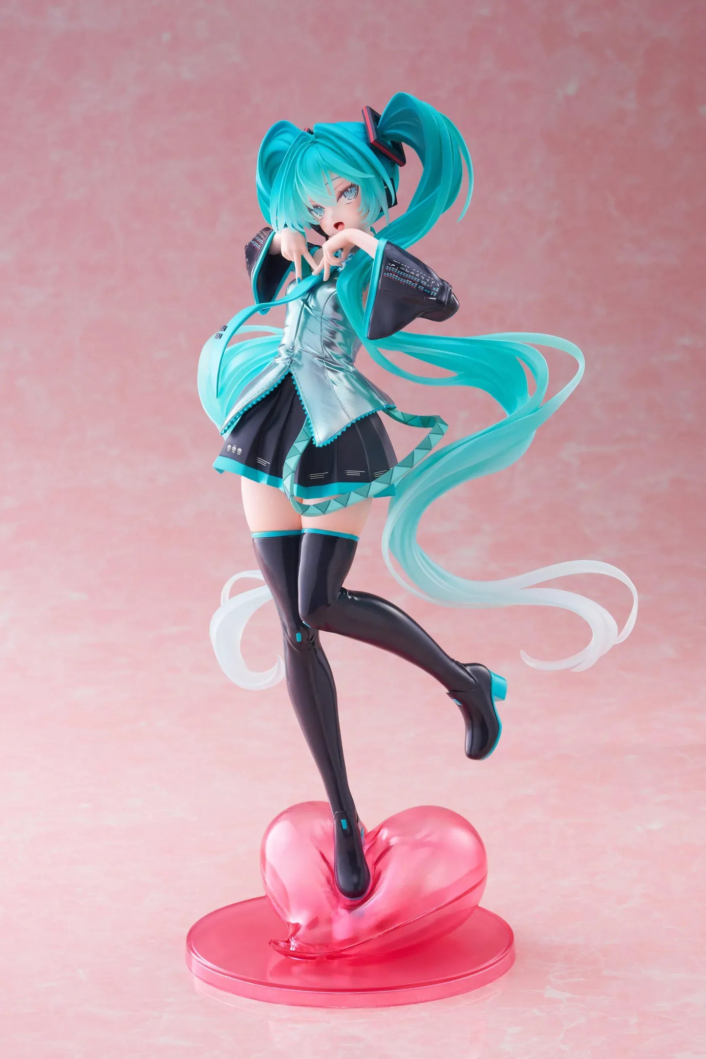 Hatsune Miku T-Most figure with flowing twin tails, classic Vocaloid outfit, and pink heart-shaped display base