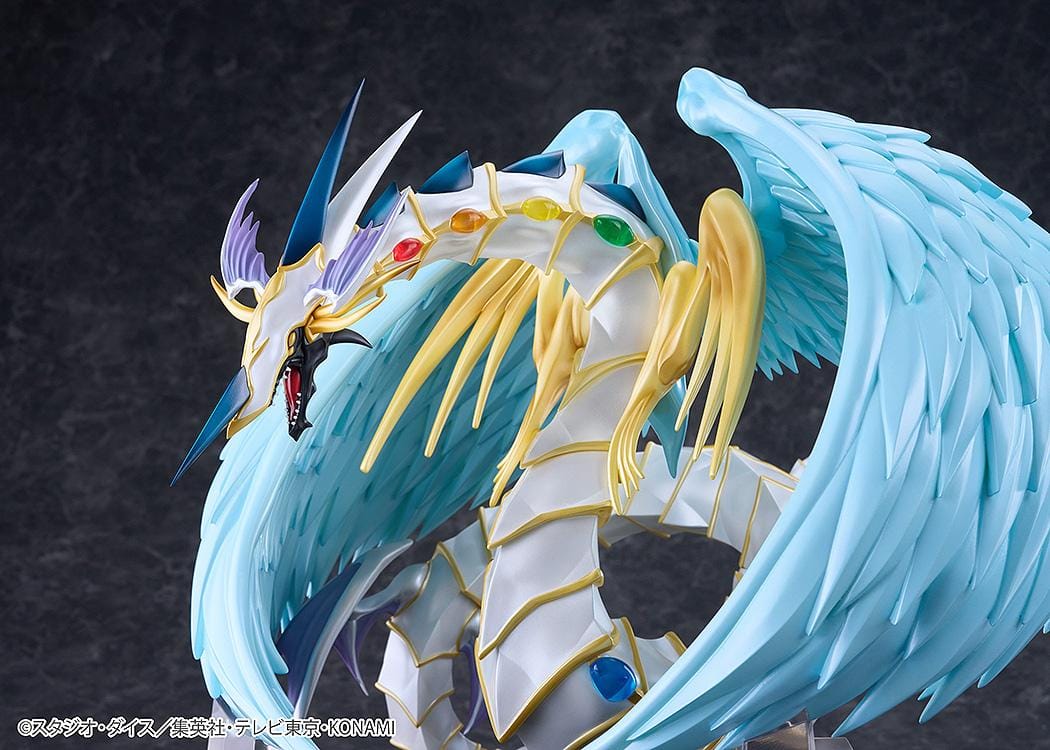 Yu-Gi-Oh! GX Rainbow Dragon figure with a pearlescent armored body, multicolored crystals, gold accents, and translucent blue wings.