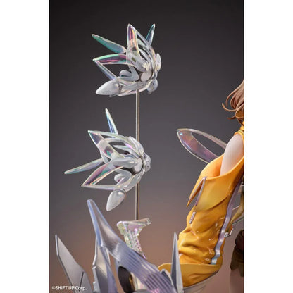 GODDESS OF VICTORY: NIKKE Anis: Star 1/7 Scale Figure featuring a brown-haired anime girl wearing a yellow jacket, white top, olive-green shorts, and sneakers, surrounded by futuristic floating mechanical accessories on a detailed display base.