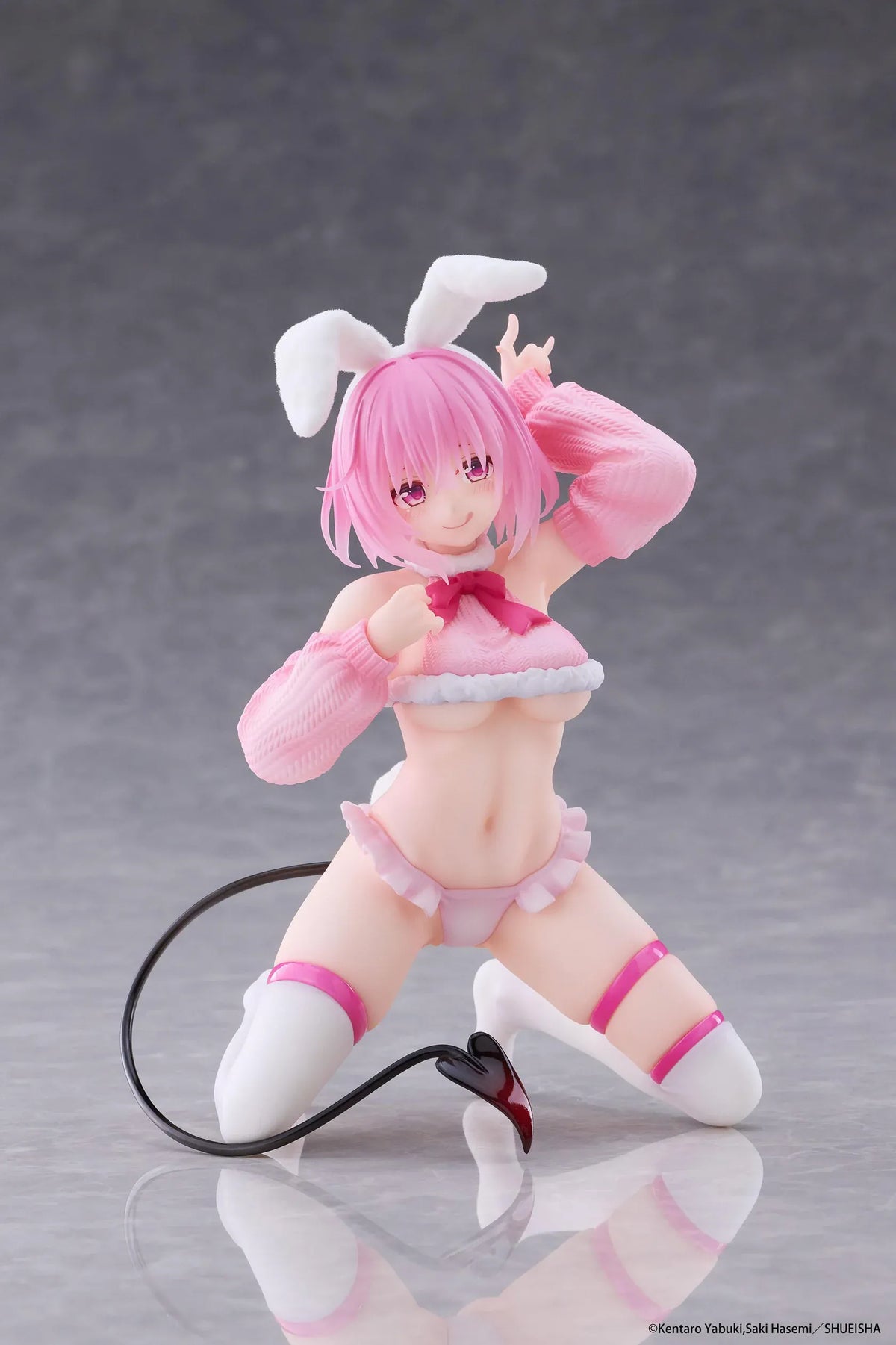 To Love-Ru Darkness MOFLOCK Momo Fluffy Bunny Ver. Figure featuring a pink-haired anime girl with pink eyes, white bunny ears, a pink fluffy bunny outfit, matching sleeves, white thigh-high stockings, and a black devil tail in a playful kneeling pose.