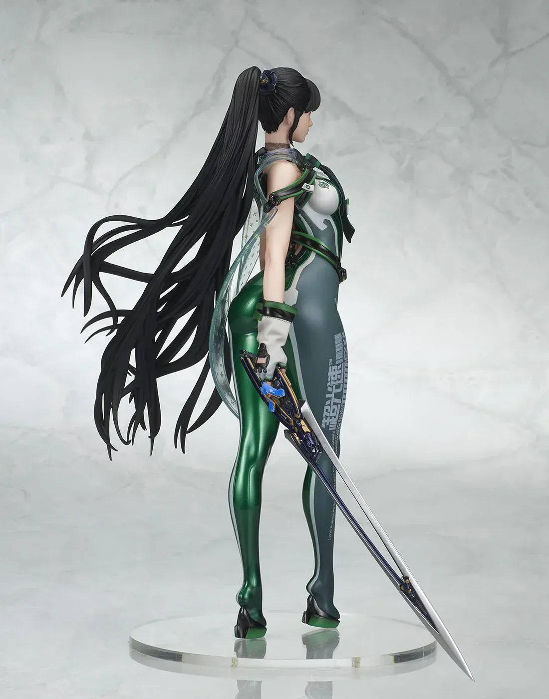 Stellar Blade Eve non-scale figure in a futuristic green and gray combat suit holding a long sword with flowing black hair