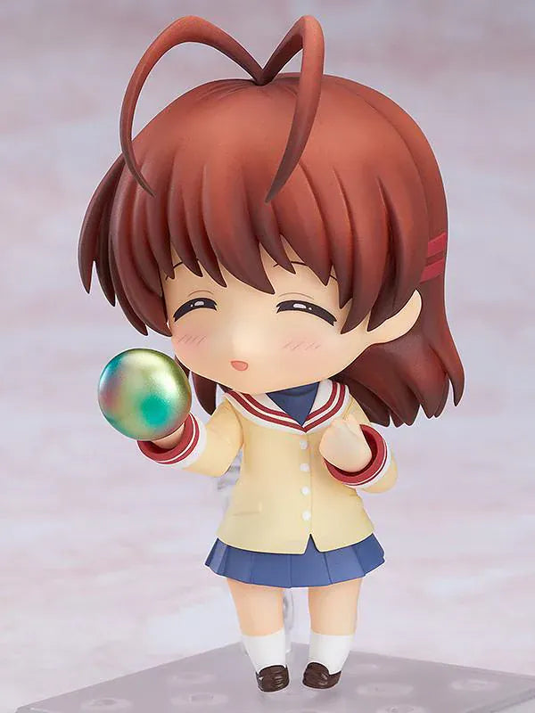 CLANNAD Nendoroid Nagisa Furukawa Figure featuring Nagisa in a chibi-style design with brown hair, cream cardigan, blue skirt, and school uniform details.