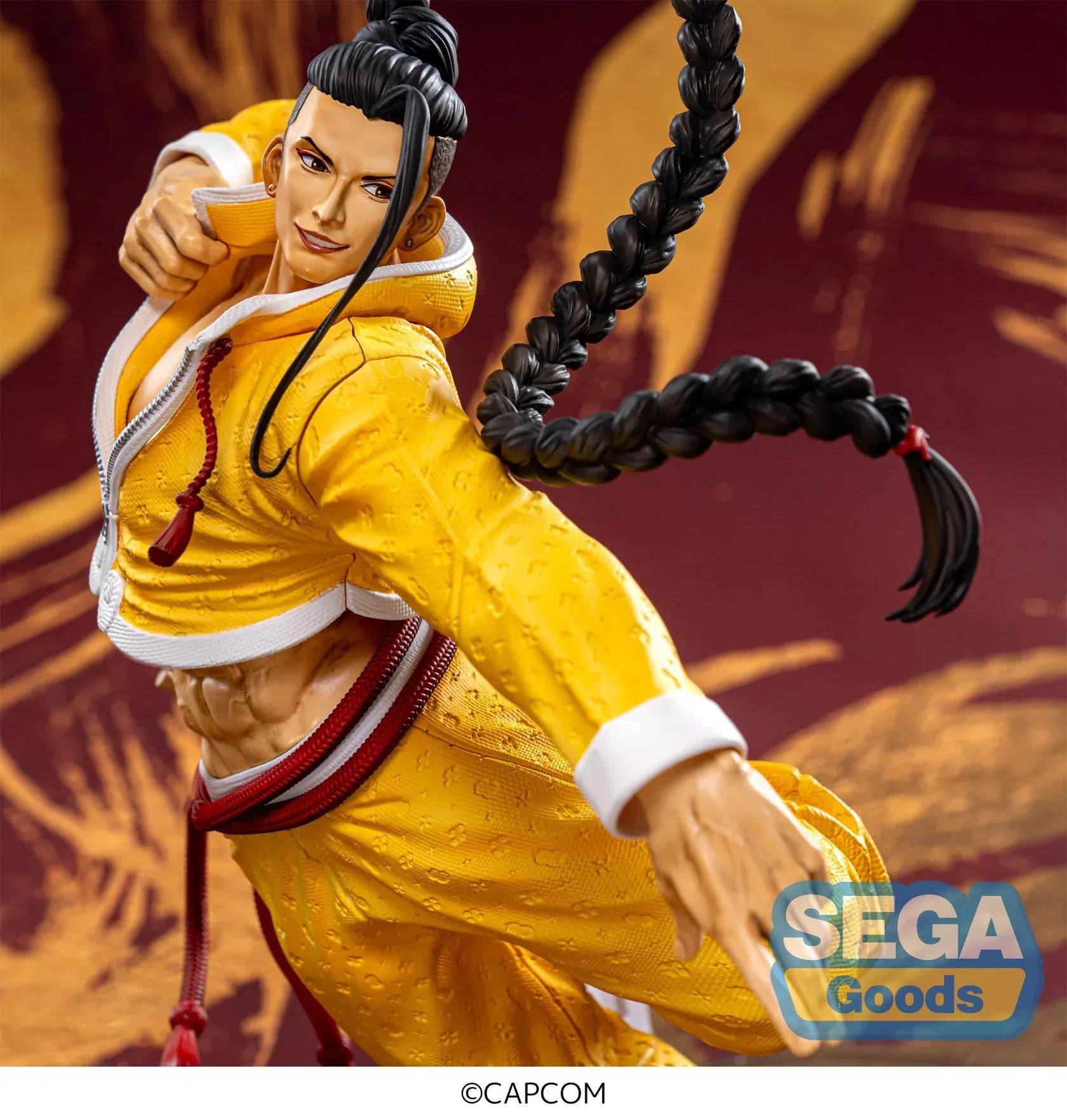 Street Fighter 6 FiGURiZMa Jamie figure in a dynamic martial arts pose with signature yellow outfit and braided hair
