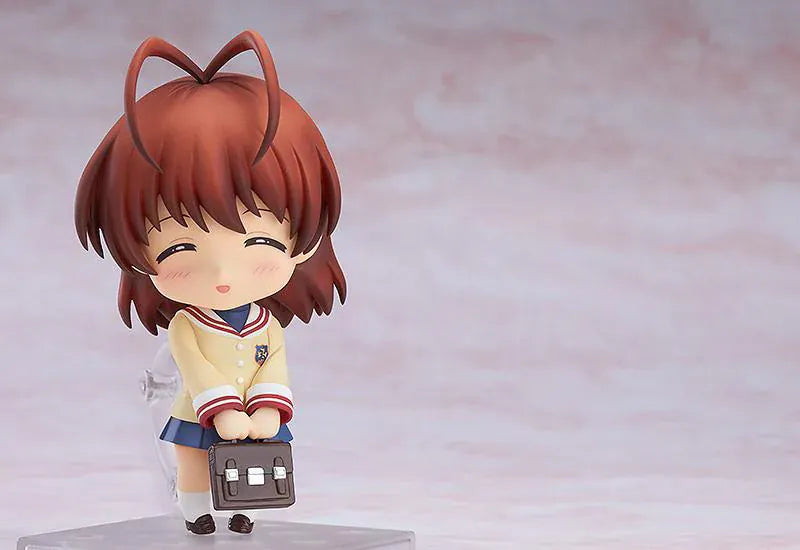 CLANNAD Nendoroid Nagisa Furukawa Figure featuring Nagisa in a chibi-style design with brown hair, cream cardigan, blue skirt, and school uniform details.