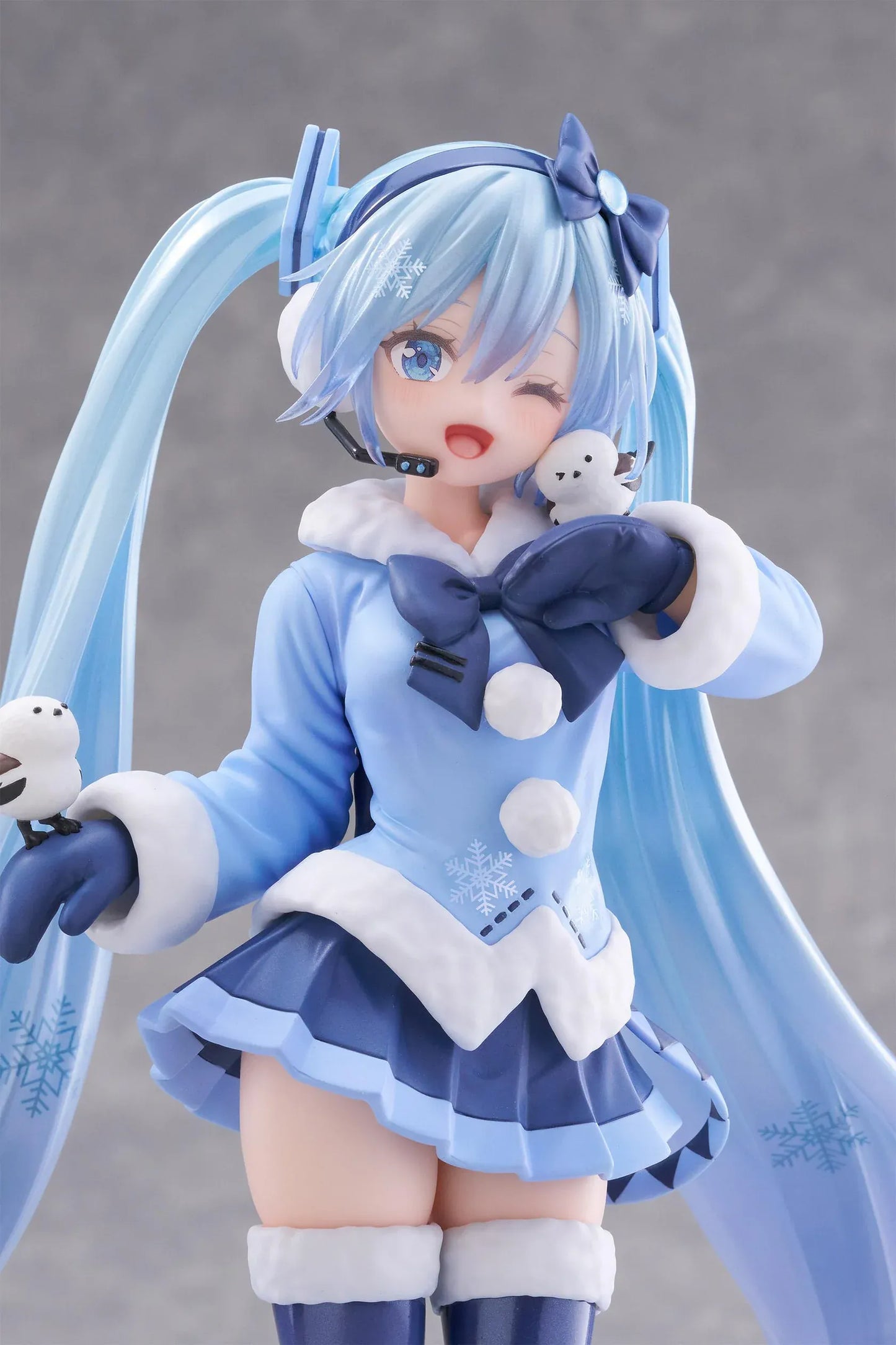 Vocaloid AMP+ Snow Miku All Stars 2012 Ver. Figure with icy blue twin-tails, winter outfit, bird details, and snowflake display base