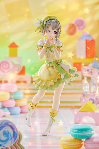 Love Live Nijigasaki High School Idol Club Kasumi Nakasu 1/7 Scale Figure featuring Kasumi in a yellow and green idol outfit with a winking expression, ribbon accents, and matching boots.