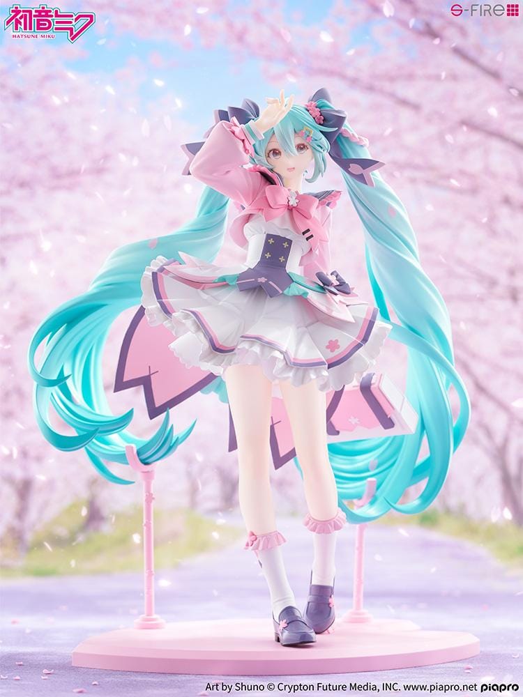 Hatsune Miku New School Term figure with turquoise twin-tails, a pink and white ruffled outfit, purple bows, and flower accents on a pink base.