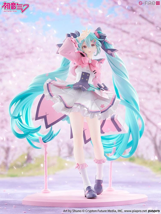 Hatsune Miku New School Term figure with turquoise twin-tails, a pink and white ruffled outfit, purple bows, and flower accents on a pink base.