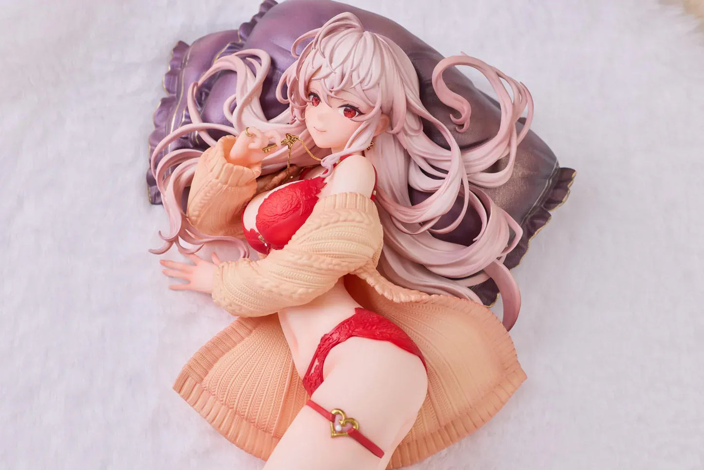 Makia 1/7 scale figure lying on a large fluffy white round base, wearing a cardigan and red lingerie, resting on a purple pillow