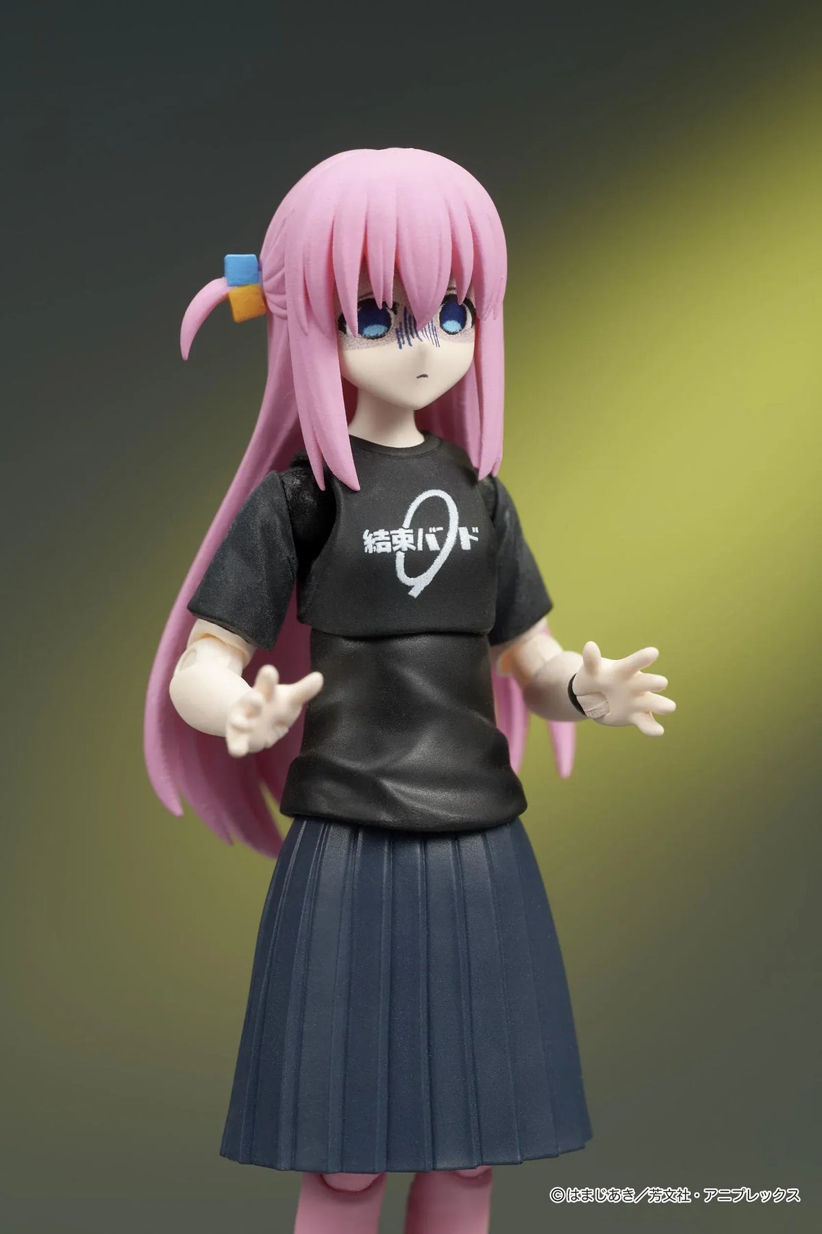 Bocchi the Rock! DIGACTION Hitori Gotoh figure holding a black and gold guitar, wearing a black band T-shirt, dark skirt, and pink leggings.