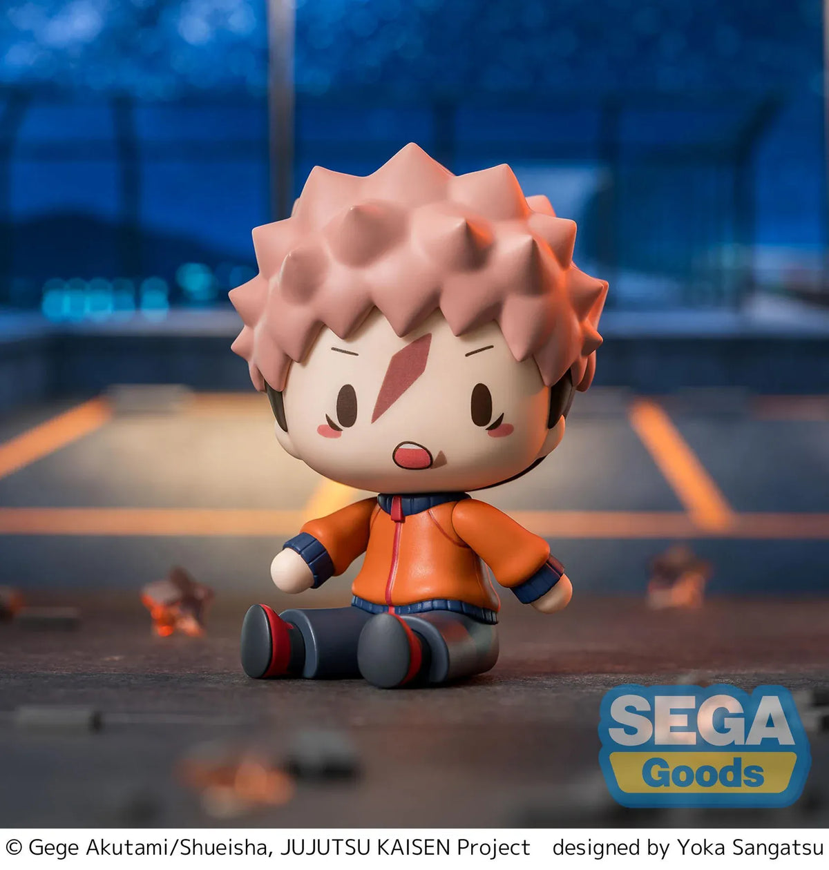 Yuji Itadori chibi figure in a seated pose with pink hair, facial markings, and an orange and navy outfit.