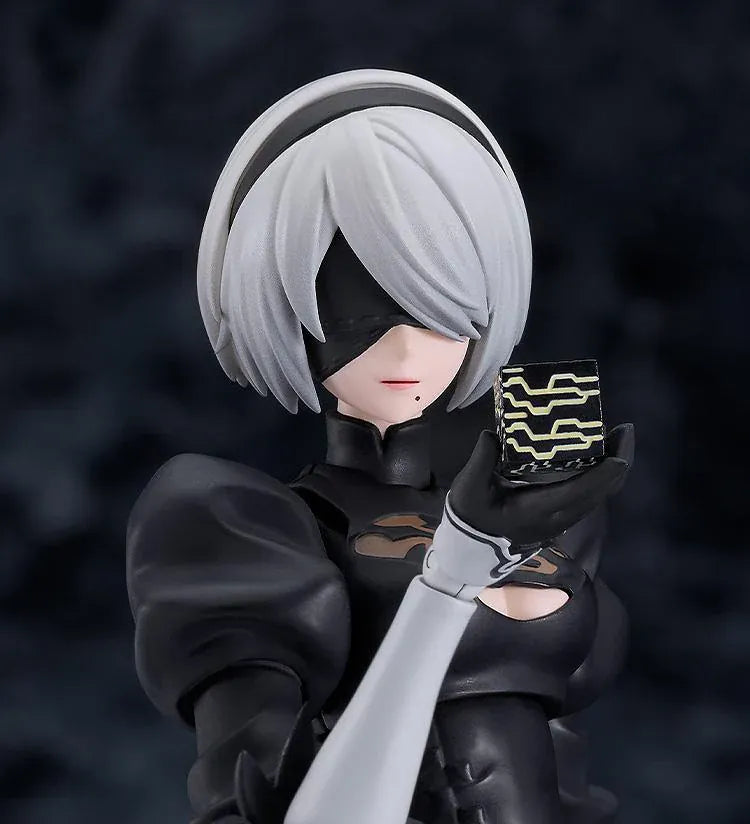 NieR Ver1.1a figma 2B figure with silver hair, a black visor, patterned black outfit, white sleeves, glossy boots, and a support robot.