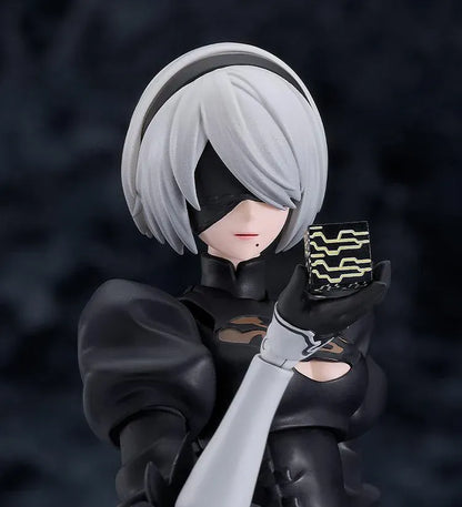 NieR Ver1.1a figma 2B figure with silver hair, a black visor, patterned black outfit, white sleeves, glossy boots, and a support robot.