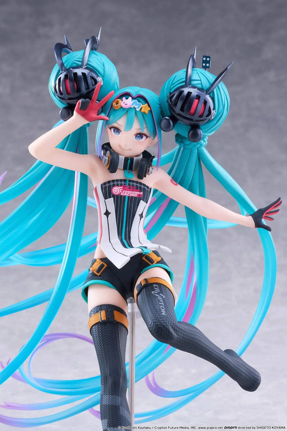 Hatsune Miku Taito Kuji Racing Miku 2026 figure wearing a futuristic racing outfit with flowing turquoise twin-tails and headphones.