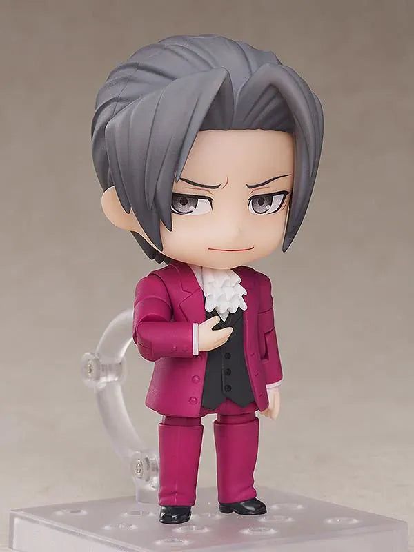 Ace Attorney Miles Edgeworth Nendoroid rerelease figure wearing a burgundy suit and pointing beside a Japanese Objection effect part.