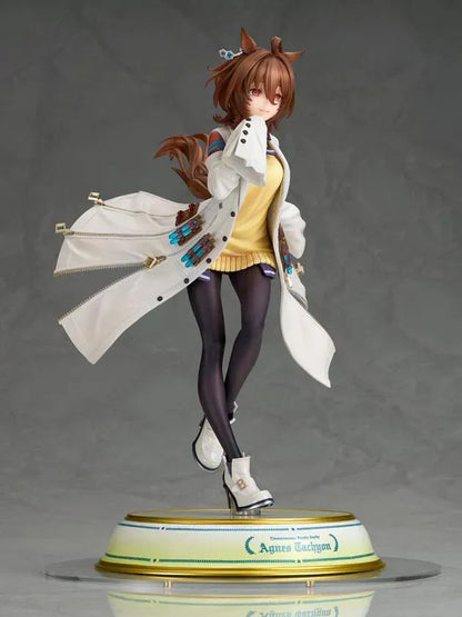 Agnes Tachyon 1/7 scale figure wearing an oversized white laboratory coat, yellow sweater, and dark tights on a decorative base.