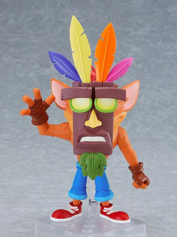 Crash Bandicoot Nendoroid rerelease figure with orange fur, a large grin, blue shorts, and red sneakers in an energetic pose.