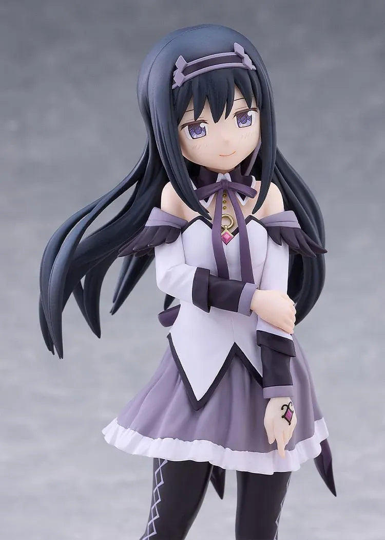 Homura Akemi figure with long black hair, violet eyes, a white and purple outfit, and diamond-patterned stockings, smiling with one hand resting on her arm.