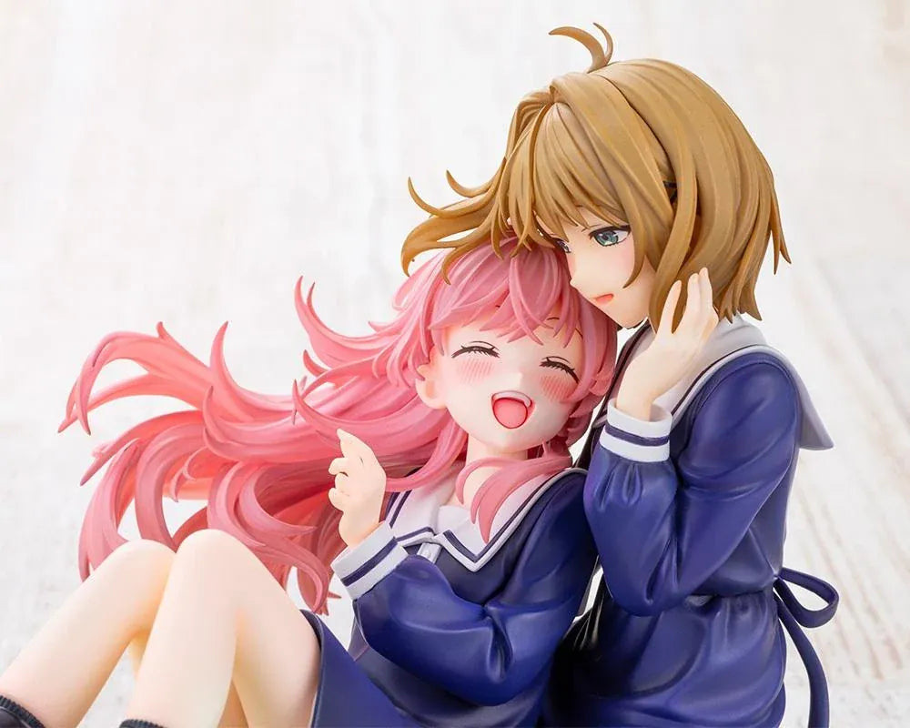 I Want to Love You Till Your Dying Day Sheena & Mimi 1/8 Scale Figure featuring pink-haired Sheena smiling with her eyes closed while leaning against blonde-haired Mimi. Both wear navy-blue school-inspired dresses and sit together on a textured grassy display base decorated with a white daisy flower crown.