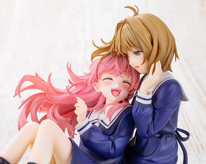 I Want to Love You Till Your Dying Day Sheena & Mimi 1/8 Scale Figure featuring pink-haired Sheena smiling with her eyes closed while leaning against blonde-haired Mimi. Both wear navy-blue school-inspired dresses and sit together on a textured grassy display base decorated with a white daisy flower crown.