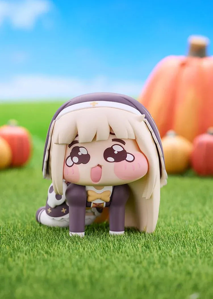 POP UP PARADE Petite Speaki figure with blonde hair, sparkling eyes, rosy cheeks, and a dark hood with gold accents and a skull detail.