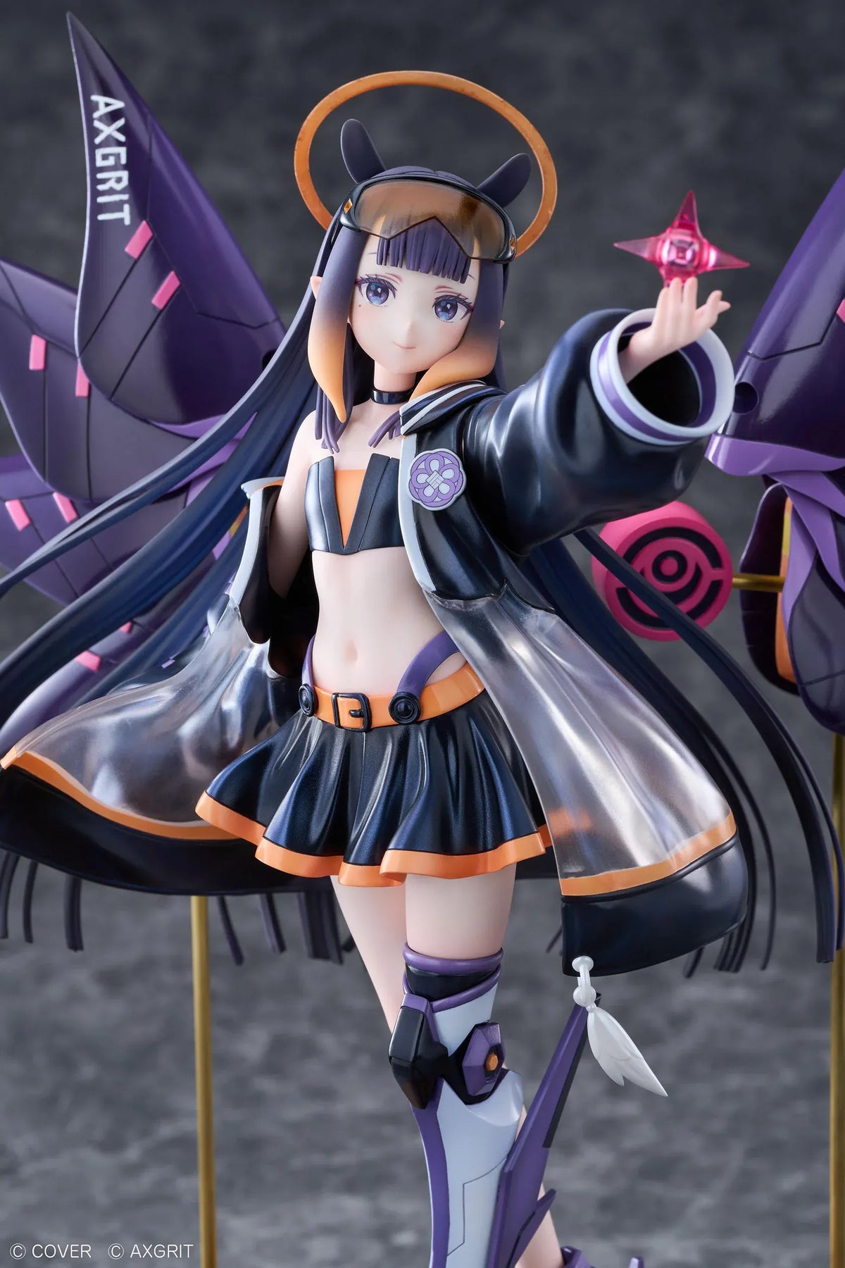 Ninomae Ina’nis AXGRIT Ver. figure with flowing dark hair, an oversized jacket, armored boots, purple mechanical elements, and orange rings above a circular base.
