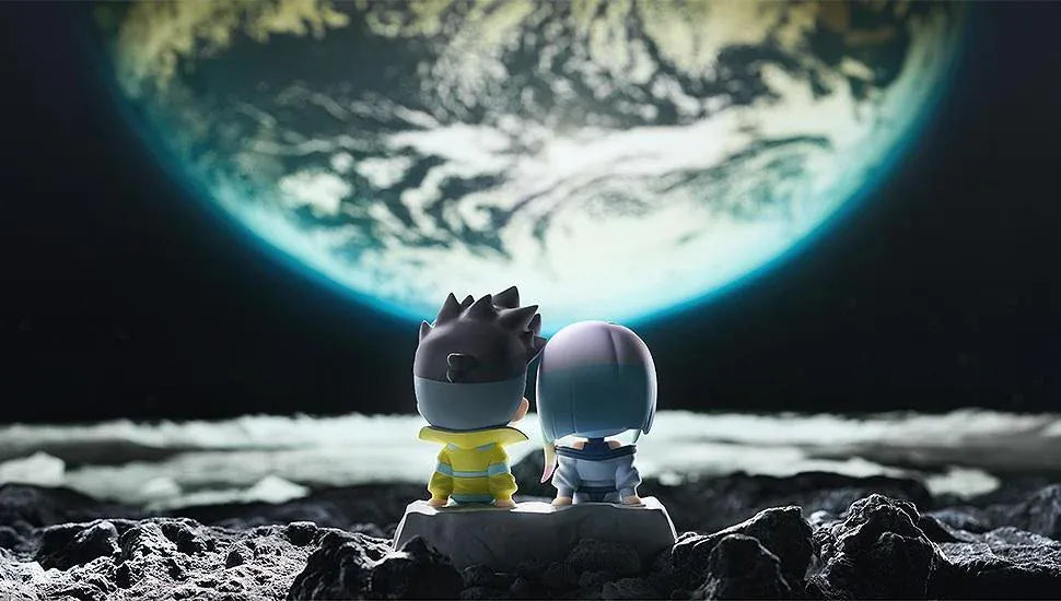 Cyberpunk: Edgerunners Qset+ David & Lucy To The Moon Figure (Rerelease) featuring chibi-style David Martinez with spiky black hair and a yellow jacket sitting beside Lucy Kushinada with pastel-colored hair and a purple futuristic outfit on a shared display base.