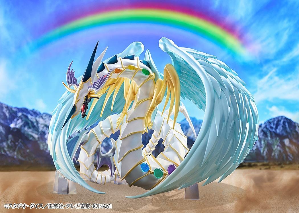 Yu-Gi-Oh! GX Rainbow Dragon figure with a pearlescent armored body, multicolored crystals, gold accents, and translucent blue wings.