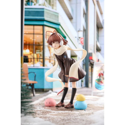 CLANNAD Nagisa Furukawa 1/6 Scale Figure featuring a smiling brown-haired anime girl wearing a dark school uniform, cream-colored scarf, white earmuffs, and black knee-high socks, surrounded by colorful Dango Daikazoku characters.
